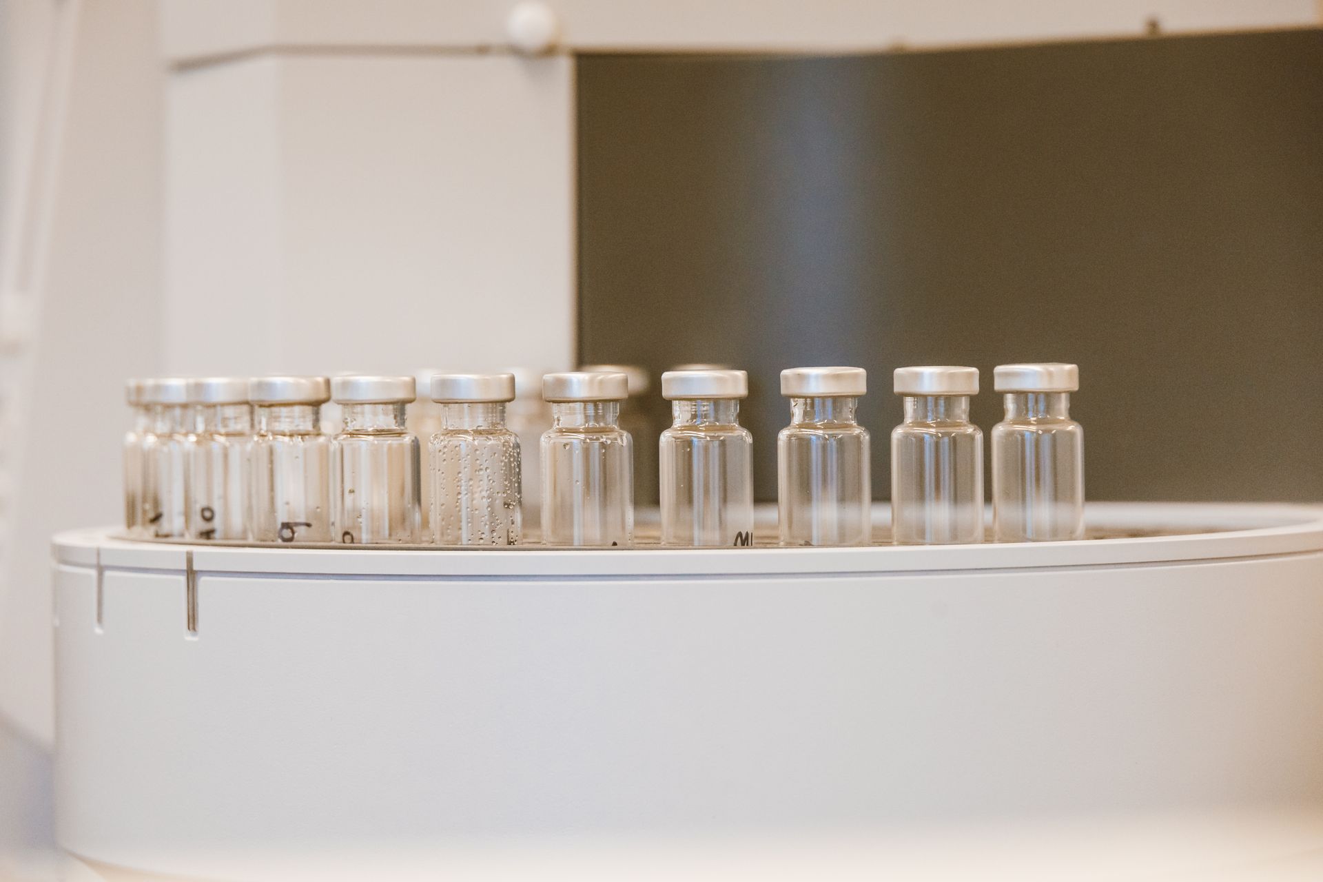 Sealed vials lined up on a pharmaceutical filling line carousel